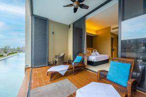 a room with a balcony with a bed and a bedroom at Greystone 99 Suites in Melaka