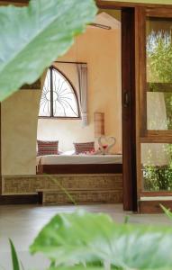 a bedroom with a bed and a window at Owa Lodge Areguling in Kuta Lombok