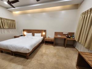 Postel nebo postele na pokoji v ubytování Hotel Gulmohar Grand