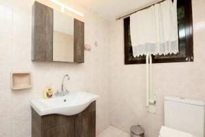 a bathroom with a sink and a toilet at Traditional house in Ano Korakiana in Áno Korakiána