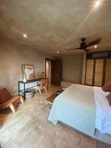 a bedroom with a bed and a ceiling fan at Villa Hele in General Luna