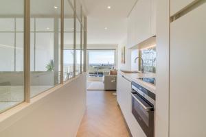 Il comprend une cuisine aux murs blancs et une grande fenêtre. dans l'établissement Lighthouse studio with amazing & beautiful sea view, à Nieuport 12 autres photos