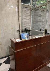 a reception desk with a laptop on top of it at Hotel Serasi 2 in Tangerang
