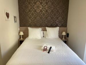 Postel nebo postele na pokoji v ubytování Hôtel Oxo
