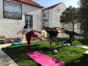 a group of people playing a game in the grass at GetWet SurfCamp II in Costa da Caparica