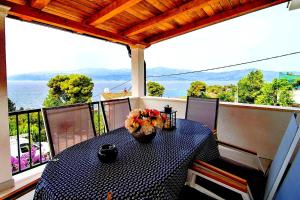 a table on a balcony with a view of the ocean at Seaview Residence in Splitska