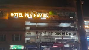 a building with a hotel patkin inn sign on it at Hotel Pratham Inn in Ahmedabad