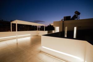 a balcony of a building with lights on it at Athens Heart Luxury Penthouse in Athens