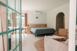 a bedroom with a bed and a table and chairs at Casa Velha Apartments - Adults friendly in Albufeira +37 photos