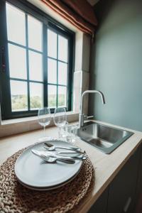 a table with two wine glasses and a sink at Casa Velha Apartments - Adults friendly in Albufeira