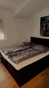 a large bed in a bedroom with at SPA RESIDENZ NEUSIEDL APPARTMENTS in Neusiedl am See