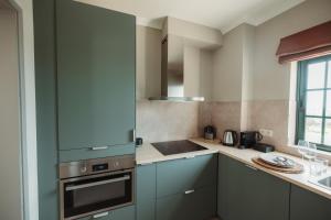 a kitchen with blue cabinets and a sink at Casa Velha Apartments - Adults friendly in Albufeira
