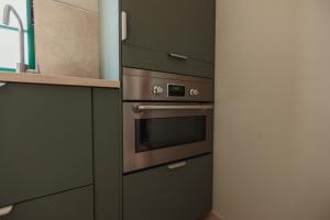 a kitchen with a stainless steel oven and cabinets at Casa Velha Apartments - Adults friendly in Albufeira