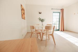 a dining room with a table and chairs at Casa Velha Apartments - Adults friendly in Albufeira