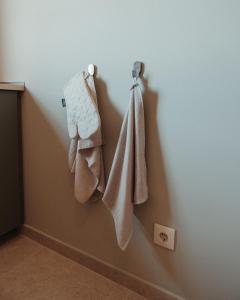 a bathroom with towels hanging on a wall at Casa Velha Apartments - Adults friendly in Albufeira