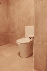a bathroom with a white toilet in a room at Casa Velha Apartments - Adults friendly in Albufeira