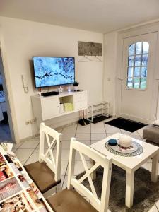 a living room with a table and a tv at Haus Vineta in Barth