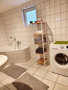 a bathroom with a toilet and a washing machine at Haus Vineta in Barth