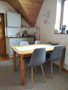 a wooden table in a kitchen with chairs around it at Privát Kováč in Tatranská Lomnica +10 photos