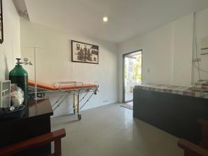a hospital room with a bed and a window at Poracay Resort powered by Cocotel in Porac