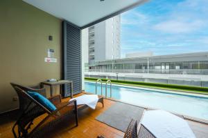 a balcony with a swimming pool in a building at Greystone 99 Suites in Malacca