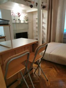 a room with a desk and two chairs and a bed at Liberty Bridge Zenta in Budapest