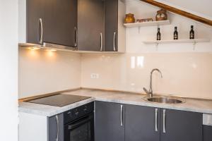 a kitchen with gray cabinets and a sink at Villa Gabi in Pridraga