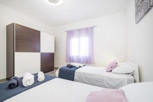 a bedroom with two beds and a window at Villa Gabi in Pridraga