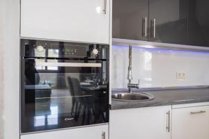a kitchen with a black oven and a sink at Villa Gabi in Pridraga
