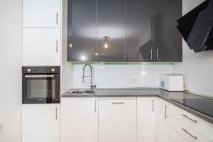 a kitchen with white cabinets and a sink at Villa Gabi in Pridraga