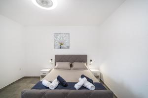 a bedroom with a bed with two pillows at Villa Gabi in Pridraga