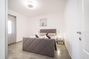 a bedroom with a couch and a bed in a room at Villa Gabi in Pridraga