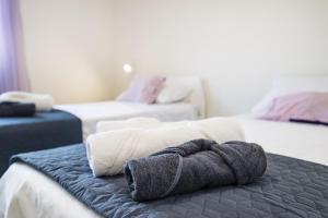 a pile of towels sitting on top of a bed at Villa Gabi in Pridraga