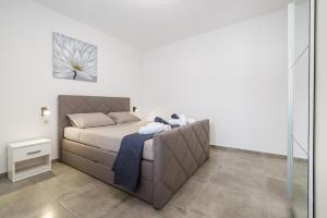 a bedroom with a bed and a glass wall at Villa Gabi in Pridraga