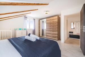a bedroom with a bed with two towels on it at Villa Gabi in Pridraga
