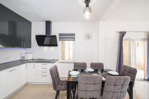 a kitchen and dining room with a table and chairs at Villa Gabi in Pridraga