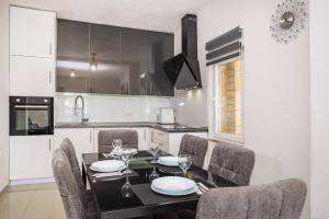 a kitchen with a dining room table and chairs at Villa Gabi in Pridraga
