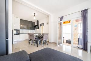 a kitchen and dining room with a table and chairs at Villa Gabi in Pridraga