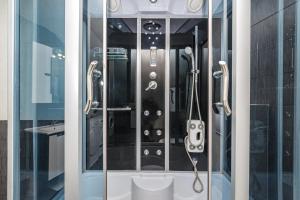 a glass shower stall with a controller in it at Villa Gabi in Pridraga