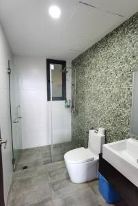 a bathroom with a toilet and a shower and a sink at Jeff and Ricky Homestay 39 @ Vivacity (Huge Unit) in Kampong Tabuan