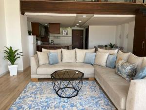 a living room with a couch and a table at Tayri - Duplex Luxe - 4 ou 5 PX in Agadir