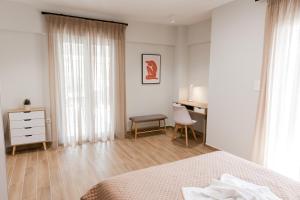 a bedroom with a bed and a desk with a chair at Athens Heart Luxury Flat in Athens