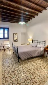 a bedroom with a large bed in a room at Casa del Marqués in Fregenal de la Sierra