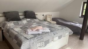 a bedroom with a bed with a baby on it at Chalupa pod Milesovkou in Milešov