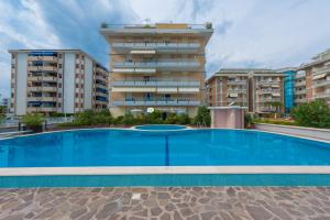 a large swimming pool in front of a building at Residence Solmare Immobiliare Pacella in Lido di Jesolo
