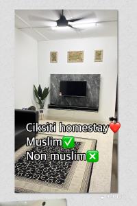 een foto van een woonkamer met een open haard bij CikSiti homestay02 in Kajang