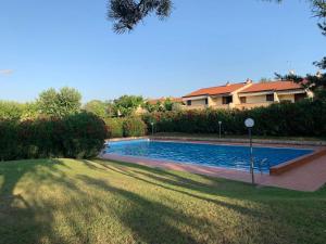 a swimming pool in a yard next to a house at Bernardi apartment il Lauro in Lazise