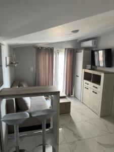 a kitchen with a table and two stools at Apartments Nera Paralia-Apartment with sea view in Paralia Katerinis