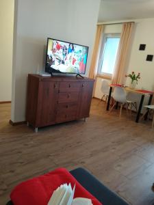 a living room with a flat screen tv on a dresser at APARTAMENT MARTA in Biłgoraj