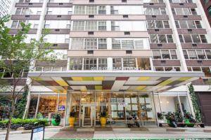 a store in front of a tall building at Gold Coast 2BR w Gym Roof nr Water Tower CHI-389 in Chicago